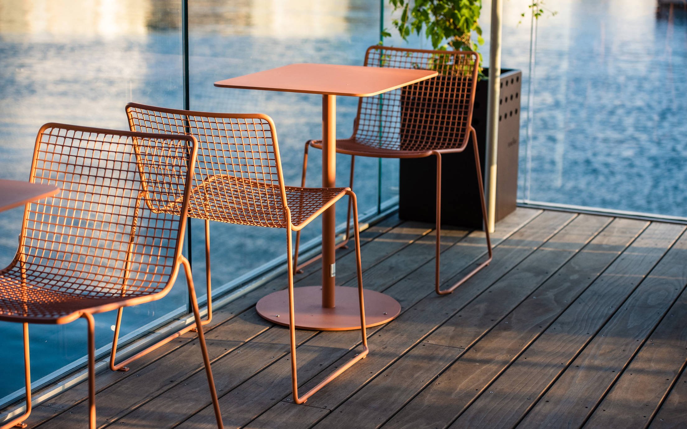 2 steel chairs and table on pool deck