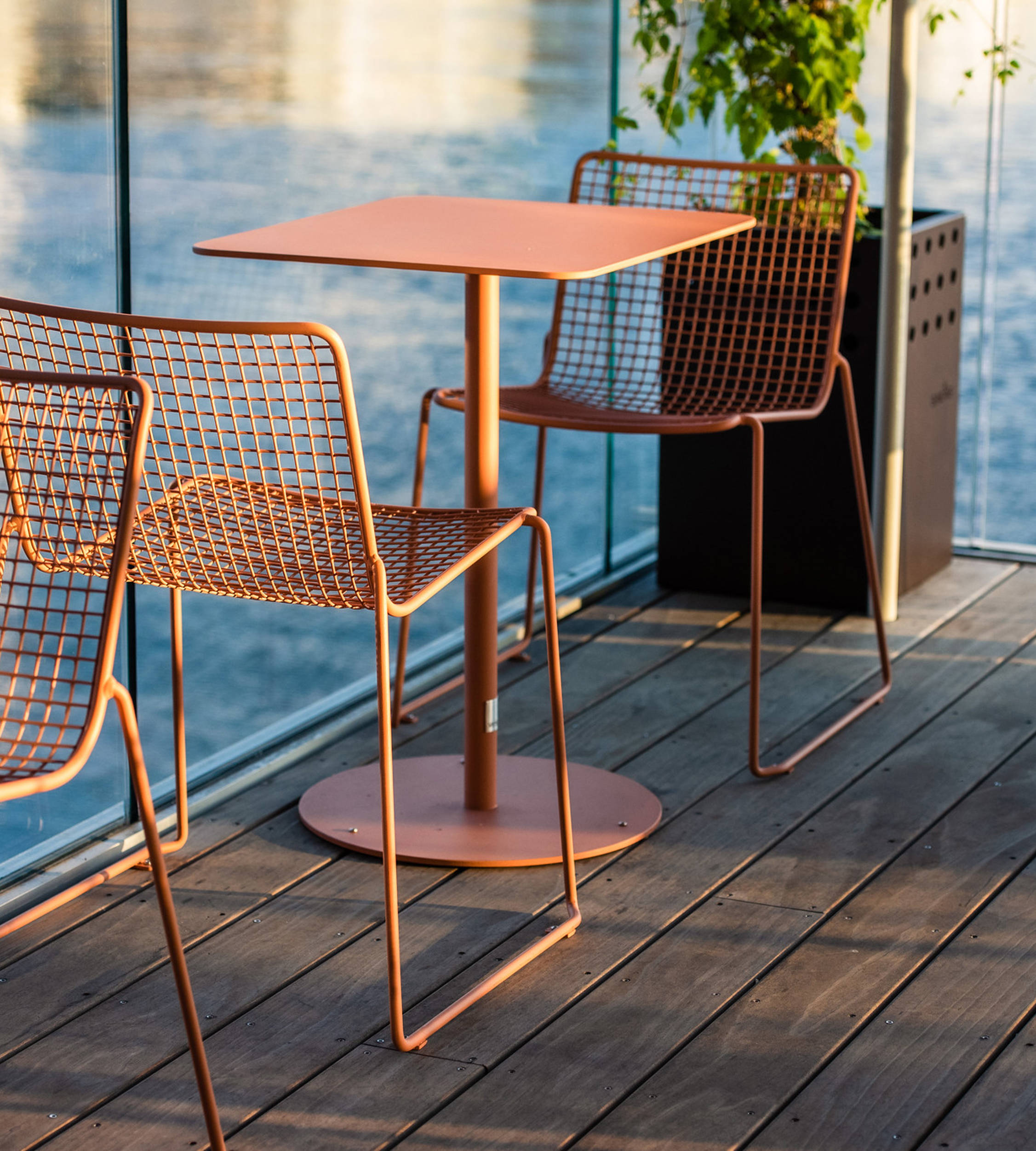 2 steel chairs and table on pool deck