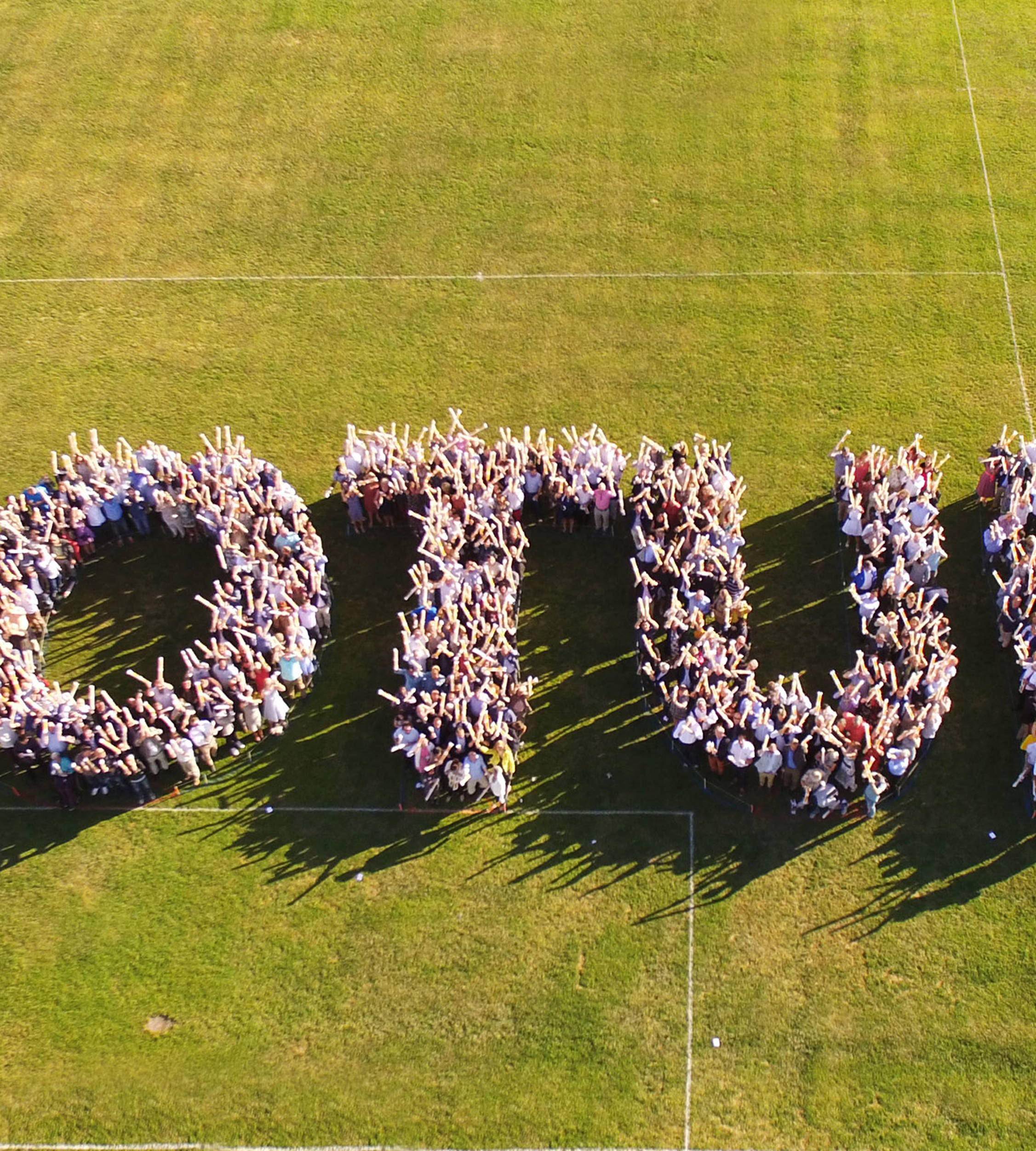 Many Jotun employees standing together outside in a formation that spell Jotun